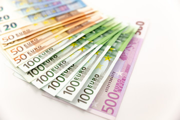 Spread Stack of Euro Banknotes, isolated close-up on white background