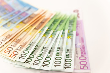 Spread Stack of Euro Banknotes, isolated close-up on white background