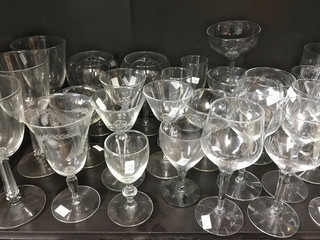 Used glass crystal stemware on a shelf in thrift store
