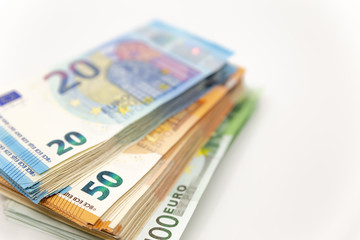 Pile of Euro Banknotes, isolated close-up on white background