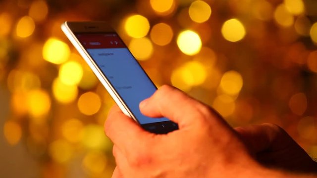 smartphone hands gold bokeh 