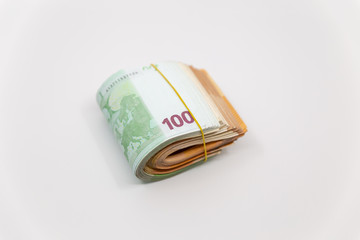 Euro Banknotes in a roll, isolated close-up on white background