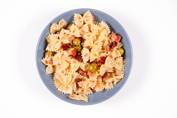 Farfalle pasta with sun dried tomato, ham and olives