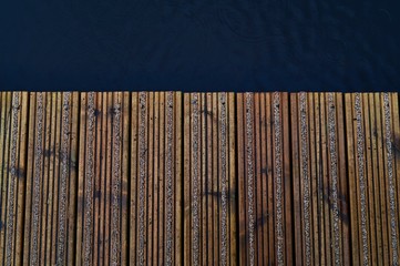 Wood Pier with Water on Side Background Top View