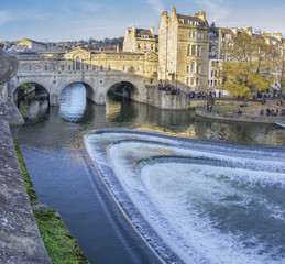 Pulteney bridge at Bath city inside the famous Cotswolds with River Avon waters crossing under the bridge during sunset. Bath, UK