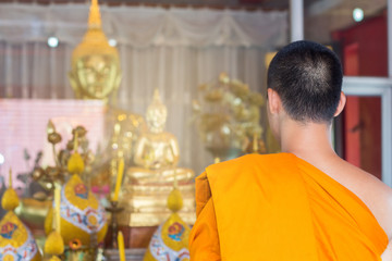 The young monk in praying according to the ordinance,the priest is praying routine