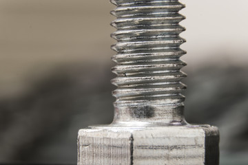 macro photo of silver bolt with nut