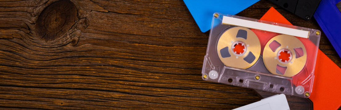 Compact Audio Cassette Tape on Wooden Background Panoramic image. Selective focus.