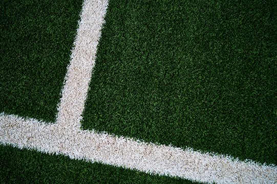 Artificial green grass football / soccer field / pitch & white stripe - close up