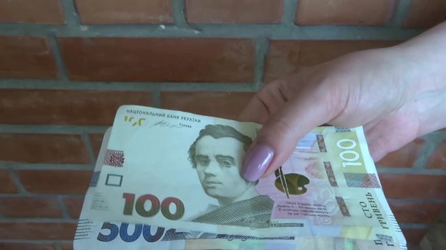 New money of Ukraine in hand. 100 and 500 UAH.