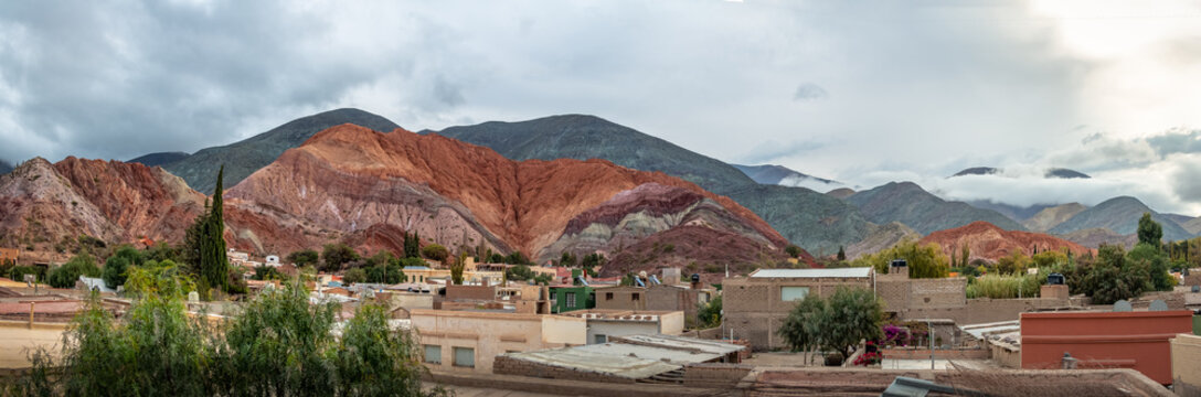 Panoramic view of Purmamarca town with the Hill of Seven Colors (Cerro de los siete colores) on background  - Purmamarca, Jujuy, Argentina