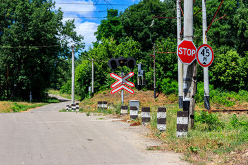 Railroad crossing over country road in forest