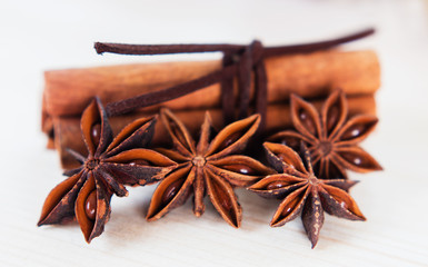 Cinnamon with brown ribbon. Closeup on wooden background