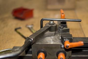 Manual mechanical steel iron metal wire bending device for industrial or work shop on a workbench