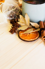 Autumn, fall leaves, hot steaming cup of glint wine