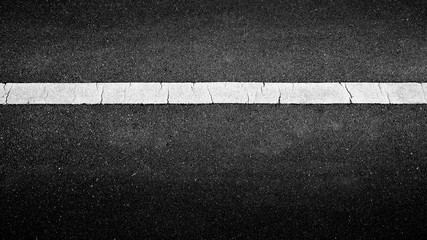 Fototapeta premium white paint line on black asphalt. space transportation background