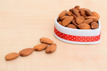 Almonds in ceramic bowl of heart shape