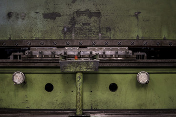 Old rustic steel processing machine for industrial production of metal goods in the past