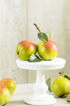Many juicy beautiful amazing nice pears on light wooden background