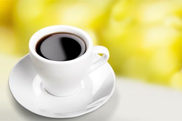 Coffee cup and coffee beans on desk