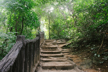 Crude stairs and wooden railings leading to next tier at Erawan Falls, in Kanchanaburi province, Thailand.