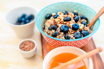 High protein healthy breakfast, buckwheat porridge with blueberries, flax seeds and honey