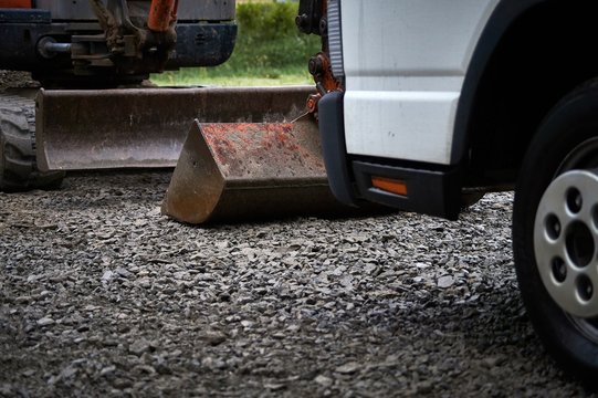Digger and truck at concrete yard construction