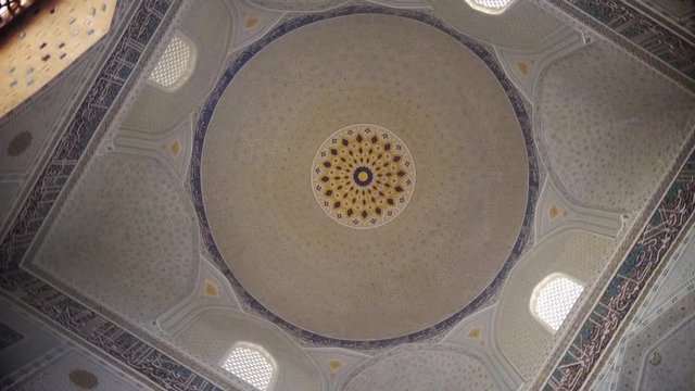 Close up shot of some Arabic decorations on a ceiling.