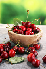 Cherry. Red fresh Cherries in bowl and a bunch of cherries on the table