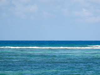 Large white horse ocean wave breaking on shore of sand