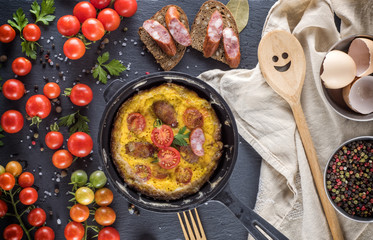  omelette from chicken eggs in a round black frying pan