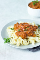 Vegetarian pasta (Tagliatelle) with zucchini, eggplant, bell pepper and tomato sauce.