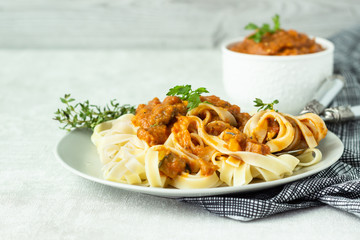 Vegetarian pasta (Tagliatelle) with zucchini, eggplant, bell pepper and tomato sauce.