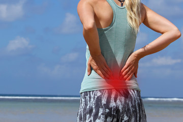 Woman runner athlete suffering from low back pain
