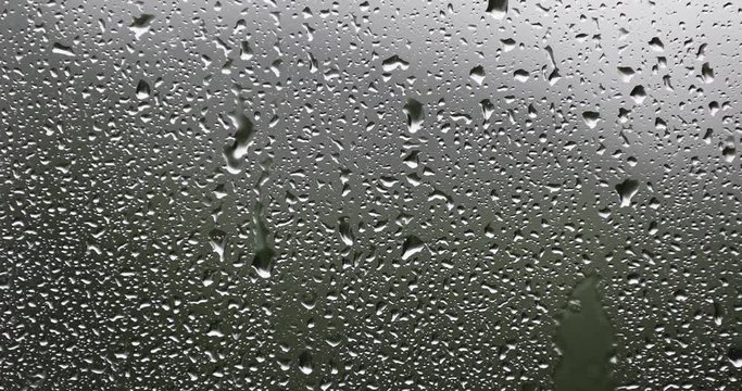 Water drops on window on a rainy day. Selective focus used.