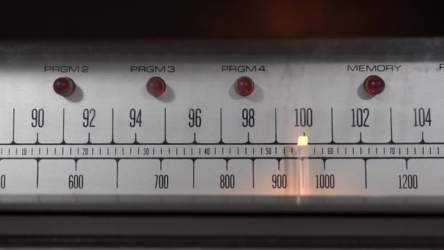 Vintage radio tuner dial moving back and forth.