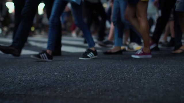 Low Shot of the Crowd of People Crossing the Road. Focus on the Legs.