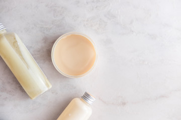 Spa cosmetics on white marble background from above. Beauty blogging concept. Copyspace