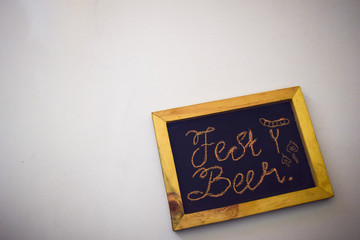 Celebrate october festival - clothes pins on grey/white background and a chalkboard with the slogan "Fest Beer"