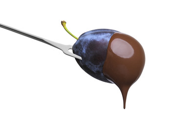 Fondue plum in hot chocolate isolated on white background