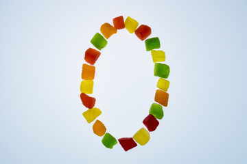  figures from multi-colored dried fruits on a white background