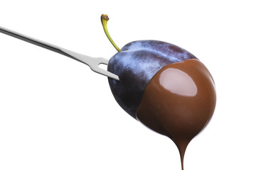 Fondue plum in hot chocolate isolated on white background