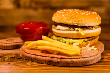 Hamburger and sauce on a wooden table