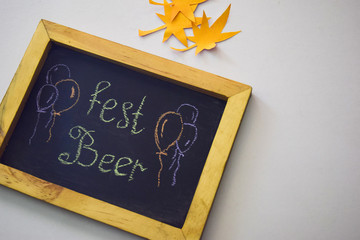 Celebrate october festival - clothes pins on grey/white background and a chalkboard with the slogan "Fest Beer"