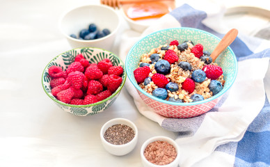 High protein healthy breakfast, buckwheat porridge with blueberries, raspberries, flax seeds and honey Closeup view, selective focus