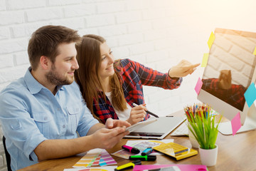 Team of creative designers working on a common project in a design studio