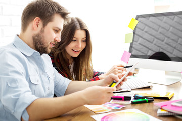 Team of creative designers working on a common project in a design studio