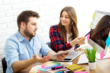 Team of creative designers working on a common project in a design studio