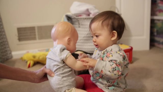 Six Month Old Baby Playing with Babydoll