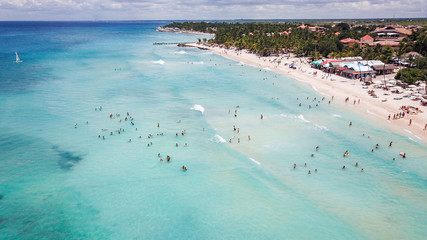 a lot of people on the beach at a resort in the Caribbean. Aerial view